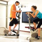 What are the similarities between an exercise bike and an elliptical trainer?