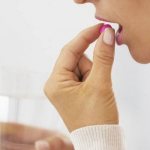 Woman taking a pill
